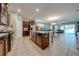 Spacious kitchen boasts granite countertops, dark wood cabinets, and stainless steel appliances at 2662 Trafalgar Blvd, Kissimmee, FL 34758