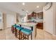 Kitchen boasts granite countertops, dark wood cabinets, and a breakfast bar with teal stools at 2662 Trafalgar Blvd, Kissimmee, FL 34758