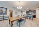 Spacious dining room features a large wooden table with a bench and a view into the kitchen at 2662 Trafalgar Blvd, Kissimmee, FL 34758