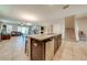 Open kitchen with granite island, stainless steel appliances, and view of living area at 2662 Trafalgar Blvd, Kissimmee, FL 34758