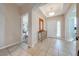 Bright and airy entryway with tile flooring, a console table, and access to other rooms at 2662 Trafalgar Blvd, Kissimmee, FL 34758