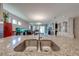 Granite kitchen island with double sink overlooking living and dining areas at 2662 Trafalgar Blvd, Kissimmee, FL 34758