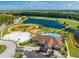 Aerial view showing community pool, sports courts, and pond at 2662 Trafalgar Blvd, Kissimmee, FL 34758