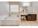 Elegant bathroom featuring a garden tub and double vanity at 2662 Trafalgar Blvd, Kissimmee, FL 34758