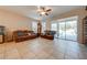 Relaxing living room with leather sofas and sliding doors to patio at 2662 Trafalgar Blvd, Kissimmee, FL 34758