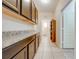 Laundry room with dark wood cabinets and granite countertops at 2662 Trafalgar Blvd, Kissimmee, FL 34758