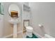 Small bathroom with pedestal sink and linen cabinet at 2662 Trafalgar Blvd, Kissimmee, FL 34758