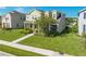 Two-story house with light beige siding, landscaping, and a walkway at 2662 Trafalgar Blvd, Kissimmee, FL 34758