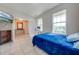 Spacious bedroom with a blue bedspread and access to a hallway at 2662 Trafalgar Blvd, Kissimmee, FL 34758