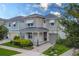 Two-story home with a neutral color palette and a metal roof at 8963 Amelia Downs Trl, Kissimmee, FL 34747