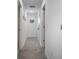 Bright hallway with neutral carpeting and decor at 8963 Amelia Downs Trl, Kissimmee, FL 34747