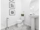 Clean and modern bathroom with pedestal sink and toilet at 8963 Amelia Downs Trl, Kissimmee, FL 34747
