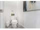 Small powder room with toilet and gray tile floor at 8963 Amelia Downs Trl, Kissimmee, FL 34747