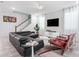 Comfortable living room, featuring a sectional sofa and two accent chairs at 8963 Amelia Downs Trl, Kissimmee, FL 34747