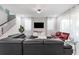 Spacious living room with a large sectional sofa and flat-screen TV at 8963 Amelia Downs Trl, Kissimmee, FL 34747