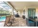 Screened pool area with patio furniture and grill at 8963 Amelia Downs Trl, Kissimmee, FL 34747