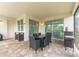 Covered patio with table, chairs, and built-in grill at 8963 Amelia Downs Trl, Kissimmee, FL 34747