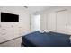 Bedroom with a queen-size bed, dresser, and private access to a bathroom at 8963 Amelia Downs Trl, Kissimmee, FL 34747