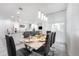 Bright dining room features a table with seating for six at 8963 Amelia Downs Trl, Kissimmee, FL 34747