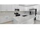 Modern kitchen featuring white cabinets, stainless steel appliances, and an island at 3112 Kacee Dr, Eagle Lake, FL 33839