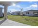 Private backyard with grassy lawn and covered patio at 806 Ballantyne Dr, Lake Wales, FL 33898