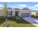 One-story house with gray siding, two-car garage, and landscaped lawn at 806 Ballantyne Dr, Lake Wales, FL 33898