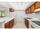 View of kitchen with wood cabinets, white countertops and appliances at 1130 N Lake Parker Ave # C129, Lakeland, FL 33805