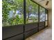 Bright screened porch with a view of lush green trees at 1130 N Lake Parker Ave # C129, Lakeland, FL 33805