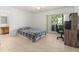 Bedroom with a plaid comforter and access to a balcony at 1130 N Lake Parker Ave # C129, Lakeland, FL 33805