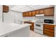 Bright kitchen features wood cabinets, white countertops, and modern appliances at 1130 N Lake Parker Ave # C129, Lakeland, FL 33805