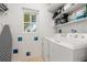 Bright laundry room with washer, dryer, and shelving at 1130 N Lake Parker Ave # C129, Lakeland, FL 33805