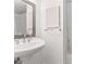 Clean bathroom with pedestal sink, shower, and decorative mirror at 1130 N Lake Parker Ave # C129, Lakeland, FL 33805