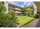 Lush courtyard with grassy area and tropical plants at 1130 N Lake Parker Ave # C129, Lakeland, FL 33805