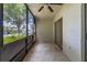 Relaxing screened porch with ceiling fan and view of parking lot at 1130 N Lake Parker Ave # C129, Lakeland, FL 33805