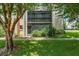 Condo exterior with screened balcony and landscaping at 1130 N Lake Parker Ave # C129, Lakeland, FL 33805