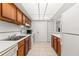 Kitchen with wood cabinets, white countertops and appliances at 1130 N Lake Parker Ave # C129, Lakeland, FL 33805