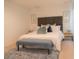 Main bedroom with king-size bed, upholstered headboard, and bench at 3006 Red Ginger Rd, Kissimmee, FL 34747