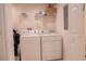 Laundry room with washer, dryer, and shelving at 3006 Red Ginger Rd, Kissimmee, FL 34747