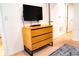 Flat-screen TV mounted above a wooden dresser at 3006 Red Ginger Rd, Kissimmee, FL 34747