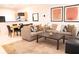Living room with beige sofa, coffee table, and patterned pillows at 3006 Red Ginger Rd, Kissimmee, FL 34747