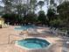 Community pool and spa with lounge chairs at 2022 Royal Bay Blvd # 93, Kissimmee, FL 34746