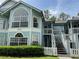 Charming light blue two-story condo with white picket fence at 2022 Royal Bay Blvd # 93, Kissimmee, FL 34746