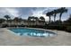 Inviting community pool area with lounge chairs and surrounding green space at 9817 Turf Way # 8, Orlando, FL 32837