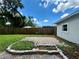 Backyard with grassy lawn, patio, and wooden fence at 1413 45Th St, Orlando, FL 32839