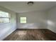 Bright bedroom with wood-look floors and large window at 1413 45Th St, Orlando, FL 32839