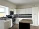 Updated kitchen with granite countertops and white cabinets at 1413 45Th St, Orlando, FL 32839