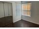 Bedroom with mirrored closet doors and hardwood floors at 2717 N Poinciana Blvd # 179, Kissimmee, FL 34746