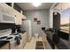 Galley kitchen with white appliances and granite countertops at 2305 Silver Palm Dr # 302, Kissimmee, FL 34747