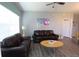 Living room with leather sofas and a wood coffee table at 2305 Silver Palm Dr # 302, Kissimmee, FL 34747