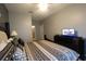 Main bedroom with king-size bed and TV at 2305 Silver Palm Dr # 302, Kissimmee, FL 34747